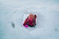 Little girl having fun in winter snow cave, kids winter fun Royalty Free Stock Photo