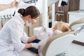 A little girl having her teeth examined by the female dentist Royalty Free Stock Photo