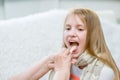 Little girl having his throat examined by health professional Royalty Free Stock Photo