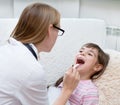 Little girl having his throat examined by health professional Royalty Free Stock Photo