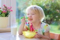 Little girl having oatmeal for breakfast Royalty Free Stock Photo