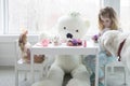 A little girl having a tea party with her toys, Royalty Free Stock Photo