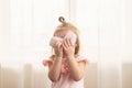 Little girl with heart shaped pillow indoor, hiding behind heart. Concept of love, happiness, kindness, gift, handmade Royalty Free Stock Photo