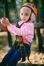 Girl riding on a zip line in an adventure rope park Royalty Free Stock Photo