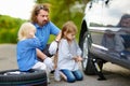 Little girl helping father to change a car wheel Royalty Free Stock Photo