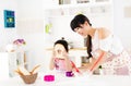 Little girl helping her mother prepare food in the kitchen Royalty Free Stock Photo