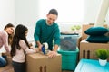 Little girl helping her parents to pack during moving day Royalty Free Stock Photo