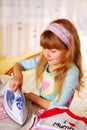 Little girl helping with ironing