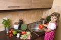 Little girl helping in kitchen