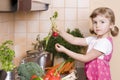 Little girl helping in kitchen