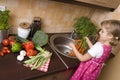 Little girl helping in kitchen