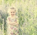 Little girl with her arms folded, spring field