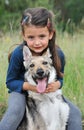 Little girl and her baby wolf dog Royalty Free Stock Photo