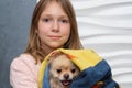 A little girl with her beloved dog in her arms. The concept of developing children`s love for animals