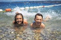 Little girl with her brother on the beach