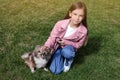 Little girl with her cute dog walking on green grass Royalty Free Stock Photo