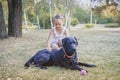 Little girl with her dog . Black Labrador head . Royalty Free Stock Photo