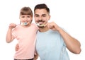 Little girl and her father brushing teeth together on white Royalty Free Stock Photo