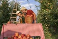 Little Girl and Her Father Eating Apples and Having Fun in an Orchard Royalty Free Stock Photo