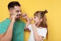 Little girl and her father flossing teeth Royalty Free Stock Photo