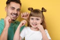 Little girl and her father flossing teeth Royalty Free Stock Photo