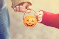 Little girl and her father, Halloween, parent and child trick or treating together. Toddler kid with jack-o-lantern. Royalty Free Stock Photo