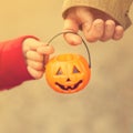 Little girl and her father, Halloween, parent and child trick or treating together. Toddler kid with jack-o-lantern. Royalty Free Stock Photo