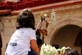 Little girl on her father`s shoulders is watching a Christ throne of the famous Holy Week in Lorca town