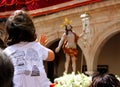 Little girl on her father`s shoulders is watching a Christ throne of the famous Holy Week in Lorca town