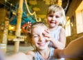 Little girl with her hand on face of her friend doing selfie Royalty Free Stock Photo