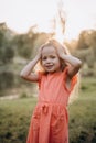 Little girl with her hands on her head and a little sad