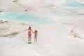 A little girl with her mother in bathing suits and sunglasses on a White mountain, a Family on a Sunny summer day on Royalty Free Stock Photo