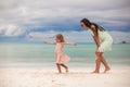 Little girl with her mother dancing at white sandy Royalty Free Stock Photo