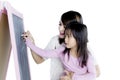 Little girl with her mother drawing with chalk