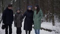 little girl and her mother and grandparents are walking in park at winter, happy family