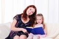 Little girl and her mother read a book Royalty Free Stock Photo