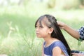 Little girl and her mother& x27;s hand arrange hair .