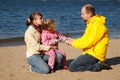 Little girl with her parents at beach Royalty Free Stock Photo