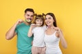 Little girl and her parents brushing teeth together Royalty Free Stock Photo