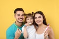 Little girl and her parents brushing teeth together Royalty Free Stock Photo