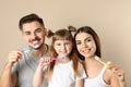 Little girl and her parents brushing teeth together Royalty Free Stock Photo