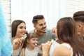 Little girl and her parents brushing teeth together near mirror in bathroom Royalty Free Stock Photo