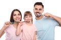 Little girl and her parents brushing teeth together Royalty Free Stock Photo