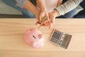 Little girl and her parents with coins and piggy bank at home. Money savings concept Royalty Free Stock Photo