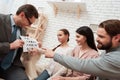 Father with a beard is taking a test with family.