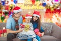 Little girl and her parents open christmas gifts box at home Royalty Free Stock Photo