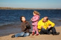 Little girl with her parents played on beach Royalty Free Stock Photo