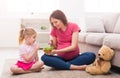 Little girl and her mom eating salad at home Royalty Free Stock Photo