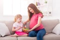 Little girl and her mom eating salad at home Royalty Free Stock Photo