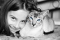 Little girl with her Siamese cat